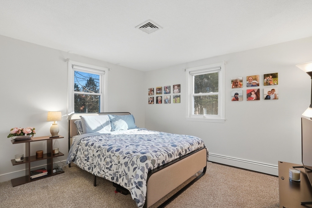 492 Elm Street Framingham, MA 01701 - Photo 11 of 27 a bedroom with a large bed and a window