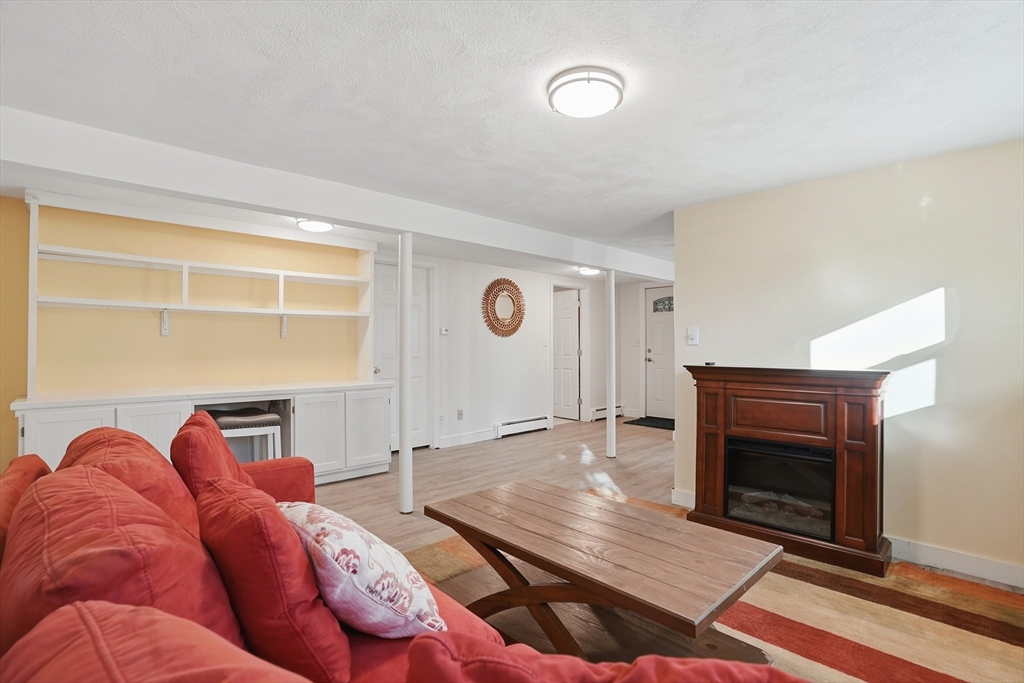 492 Elm Street Framingham, MA 01701 - Photo 15 of 27 a living room with furniture and a fireplace
