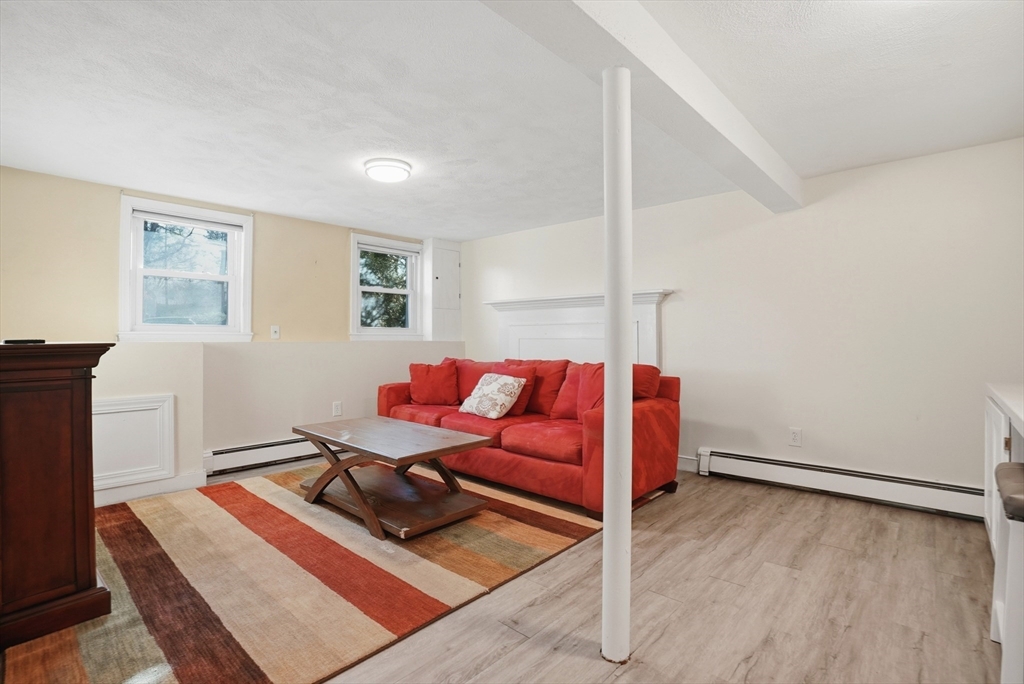 492 Elm Street Framingham, MA 01701 - Photo 16 of 27 a living room with a bed furniture and a window