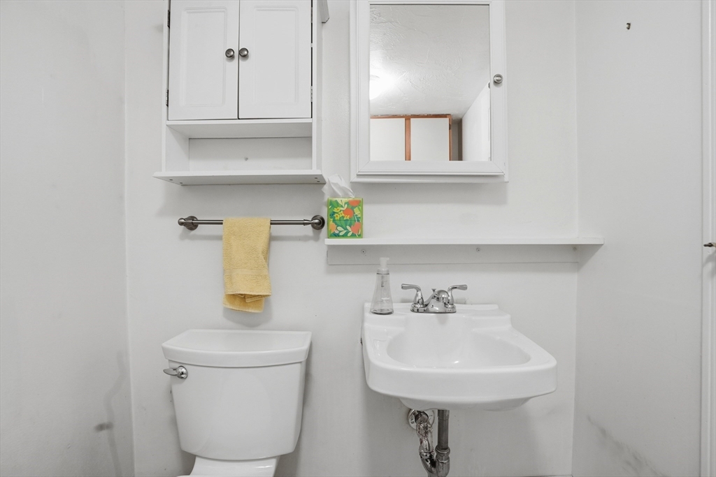 492 Elm Street Framingham, MA 01701 - Photo 18 of 27 a bathroom with a sink a toilet and mirror