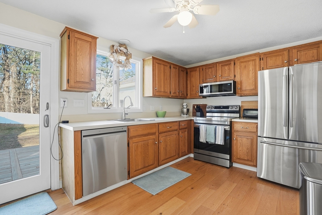 492 Elm Street Framingham, MA 01701 - Photo 4 of 27 a kitchen with granite countertop stainless steel appliances a sink cabinets and a window