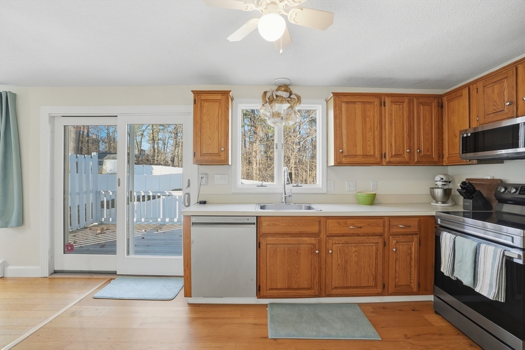 492 Elm Street Framingham, MA 01701 - Photo 5 of 27 a kitchen with a sink window and cabinets