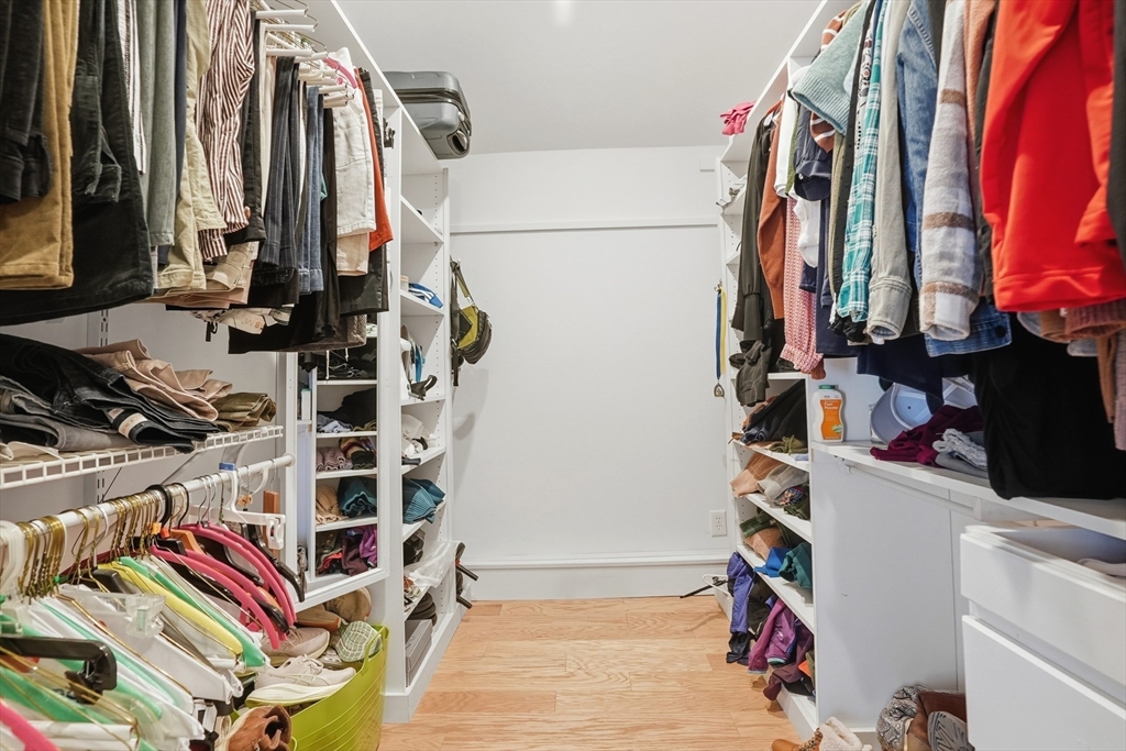 492 Elm Street Framingham, MA 01701 - Photo 9 of 27 a view of walk in closet with clothes and shoes