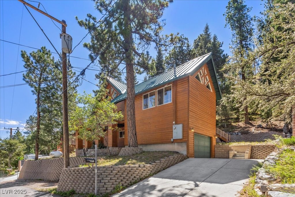370 Alpine Way Mount Charleston, NV 89124 - Photo 52 of 79 Driveway with 2-car parking and additional 1-car parking beside the block wall.