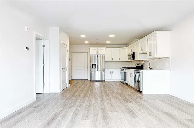 a view of kitchen with wooden floor