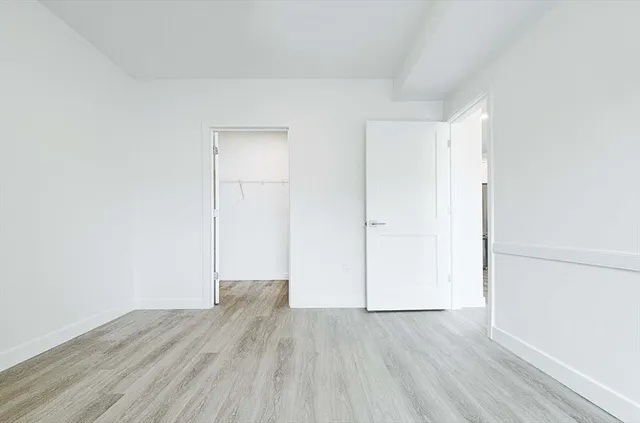 an empty room with wooden floor