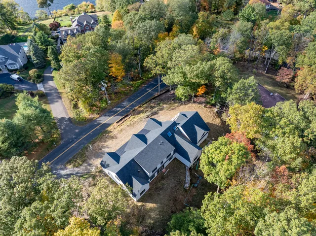 an aerial view of a house with a yard