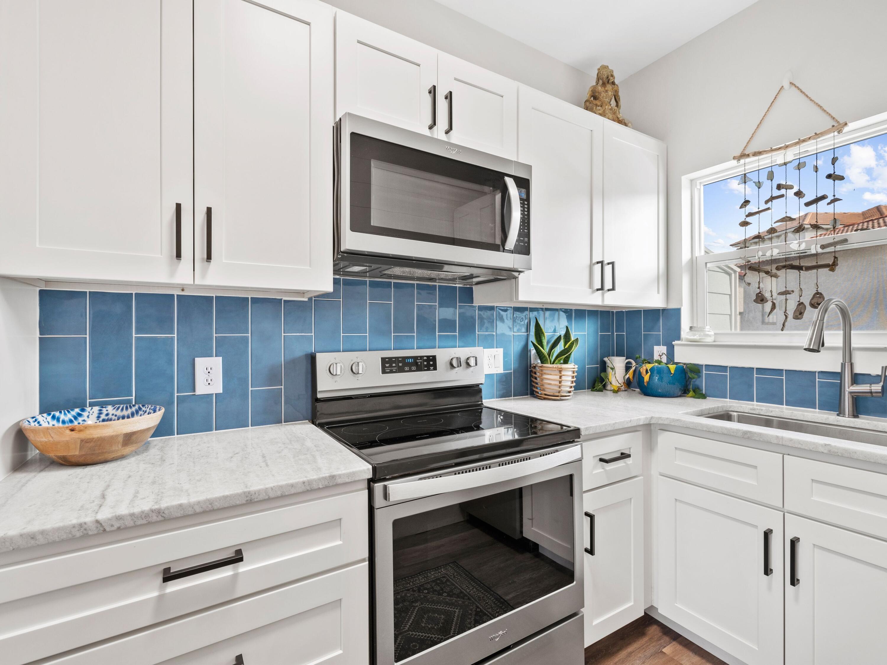 209 Blue Mountain Road, Unit 302 Santa Rosa Beach, FL 32459 - Photo 13 of 40 a kitchen with cabinets appliances and a sink