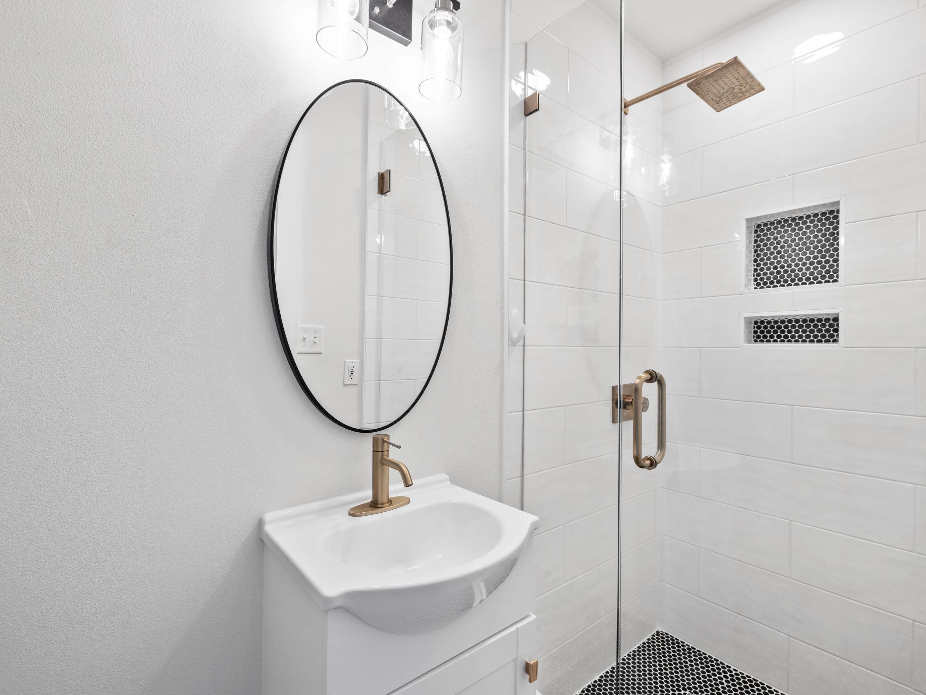 209 Blue Mountain Road, Unit 302 Santa Rosa Beach, FL 32459 - Photo 19 of 40 a bathroom with a sink a mirror and a shower