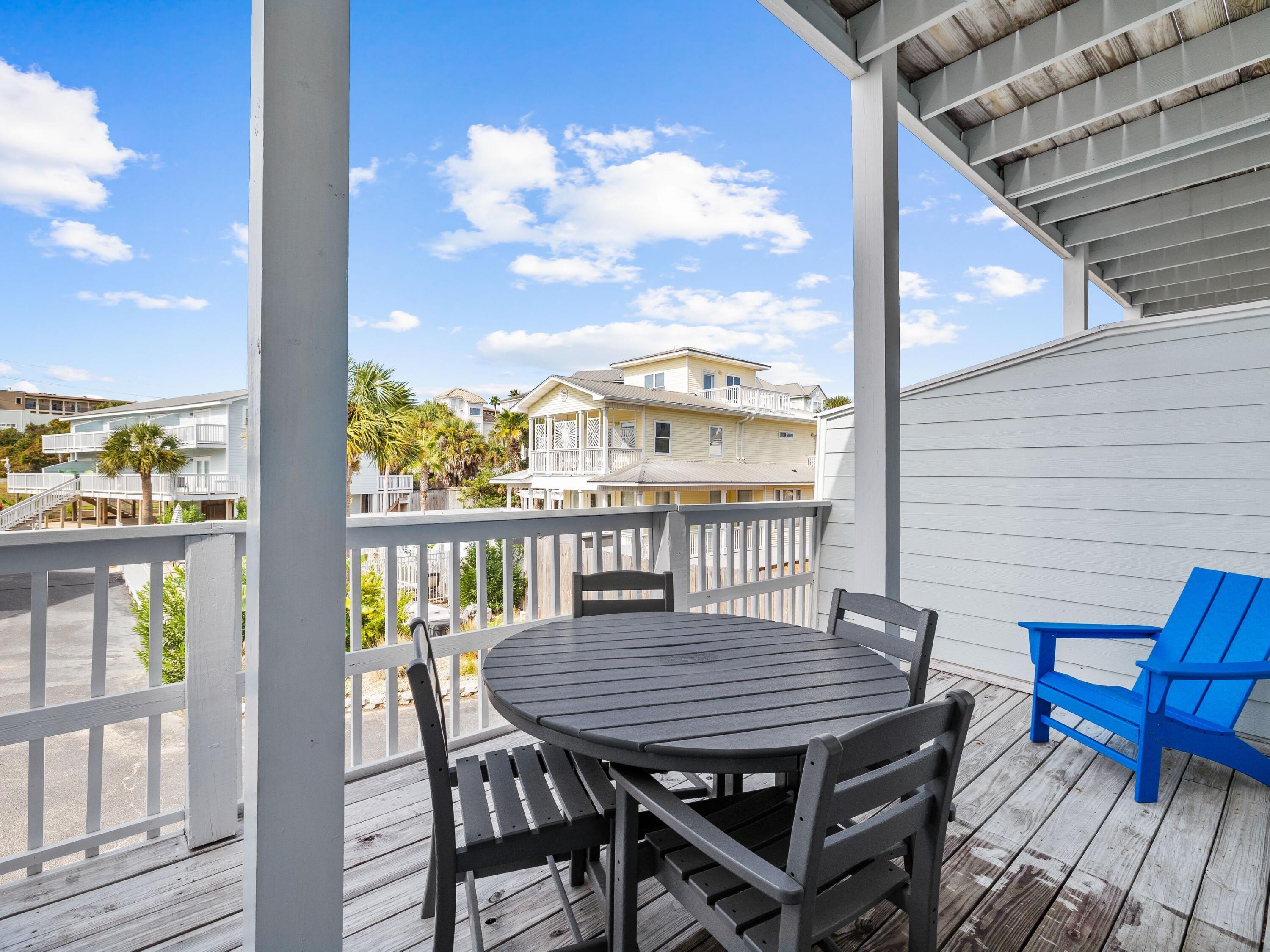 209 Blue Mountain Road, Unit 302 Santa Rosa Beach, FL 32459 - Photo 22 of 40 a view of a balcony with a table and chairs