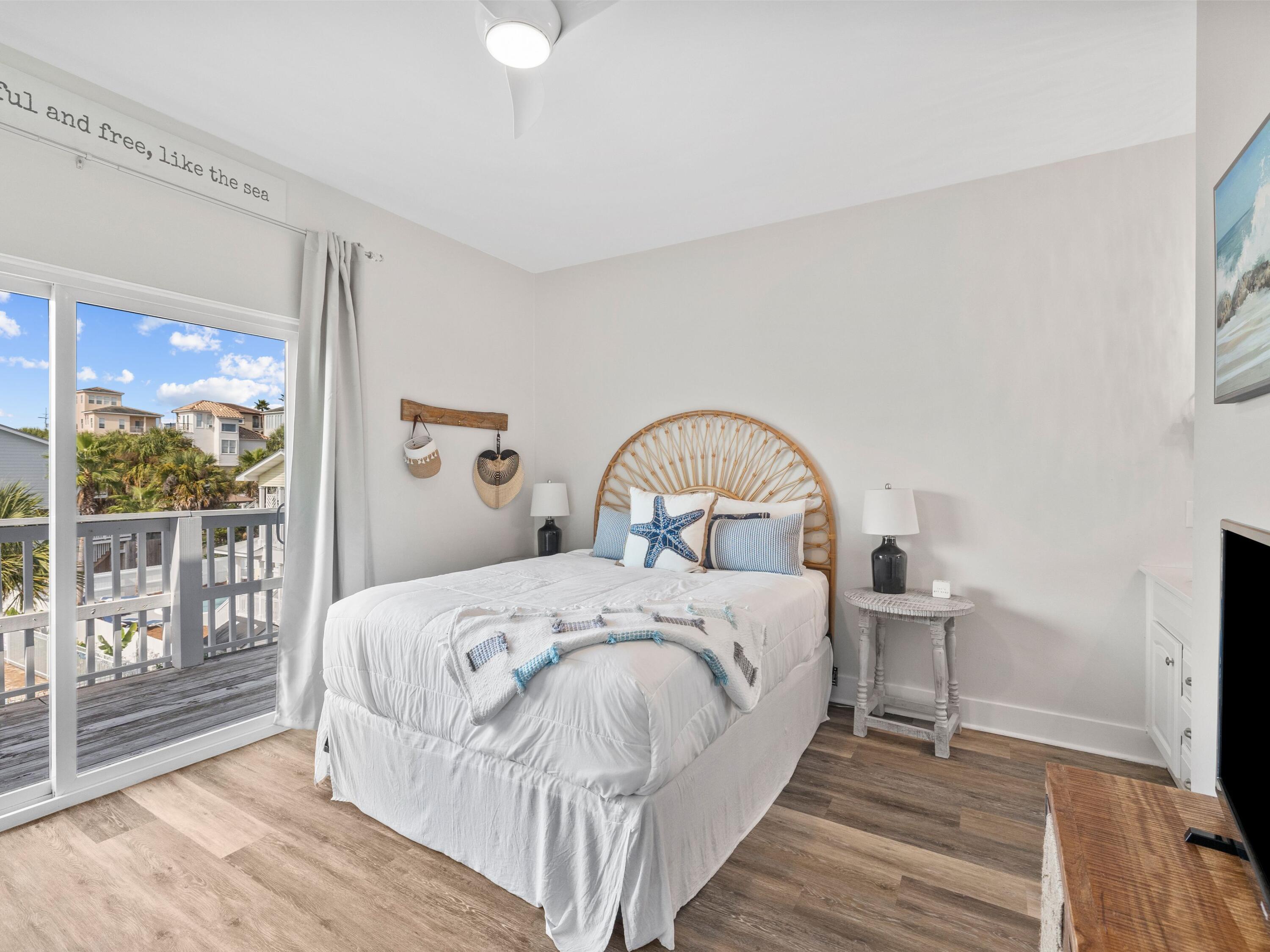 209 Blue Mountain Road, Unit 302 Santa Rosa Beach, FL 32459 - Photo 24 of 40 a bedroom with a bed and a large window