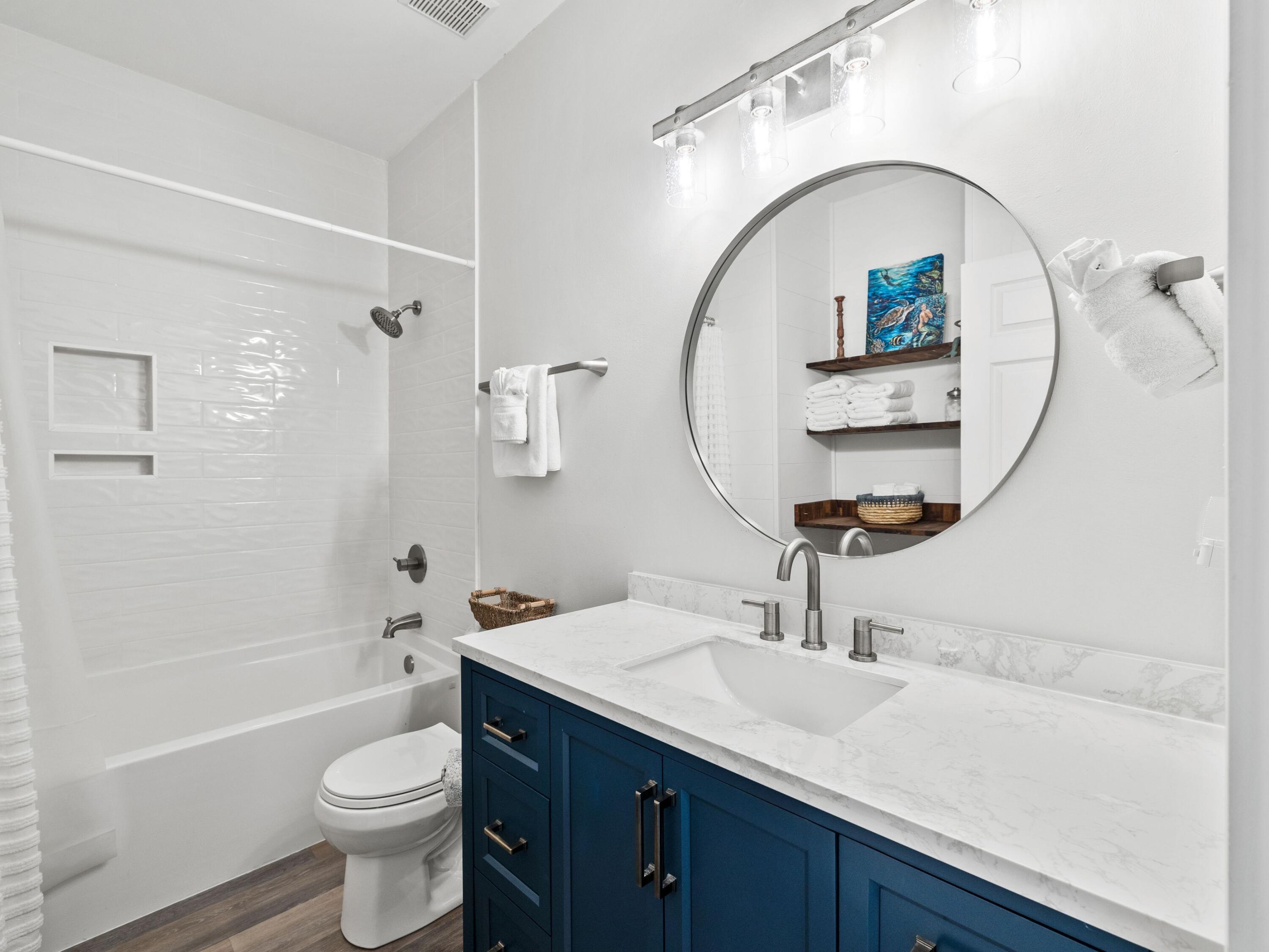 209 Blue Mountain Road, Unit 302 Santa Rosa Beach, FL 32459 - Photo 30 of 40 a bathroom with a sink a toilet and a mirror