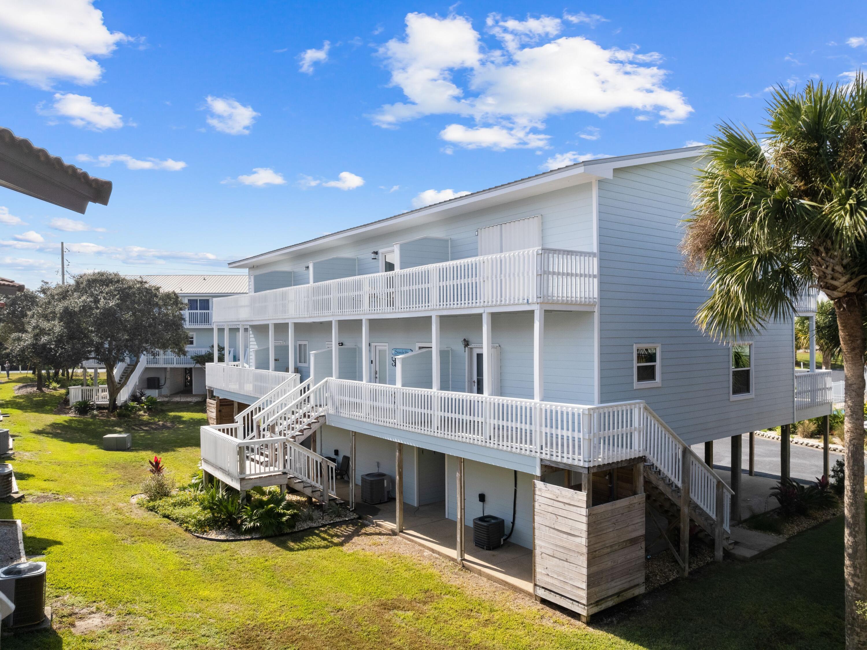 209 Blue Mountain Road, Unit 302 Santa Rosa Beach, FL 32459 - Photo 7 of 40 a front view of a house with a yard balcony