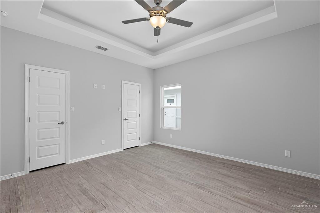 1908 Stauffers Street, Unit 1 Weslaco, TX 78596 - Photo 13 of 14 wooden floor in an empty room with a window