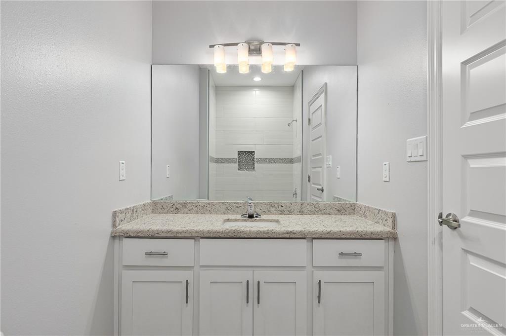 1908 Stauffers Street, Unit 1 Weslaco, TX 78596 - Photo 14 of 14 a bathroom with a sink and a mirror