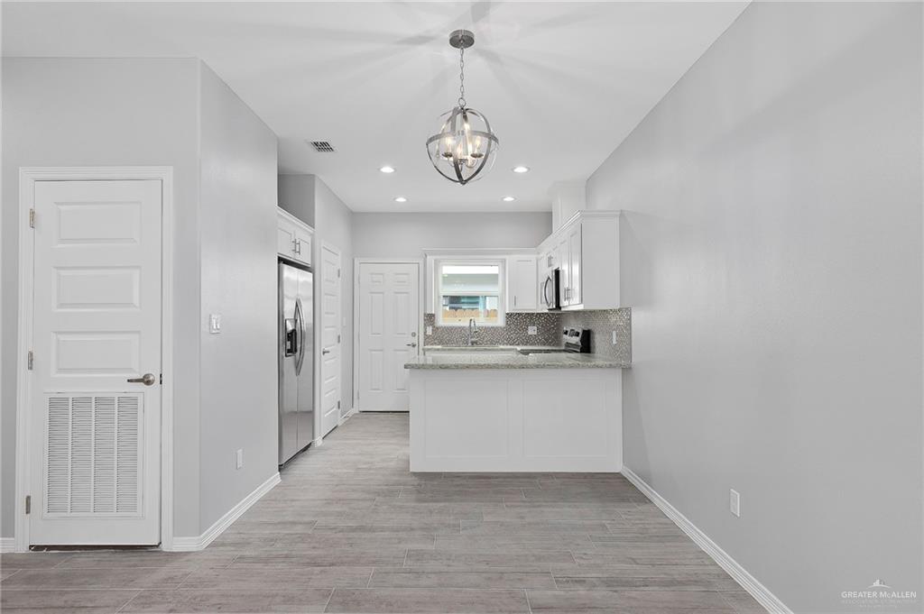 1908 Stauffers Street, Unit 1 Weslaco, TX 78596 - Photo 3 of 14 a view of a kitchen with a sink a refrigerator and window