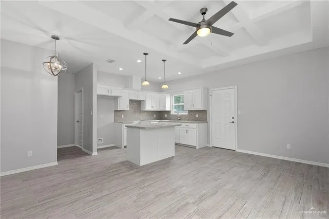 a kitchen with granite countertop white cabinets white appliances and a granite counter tops