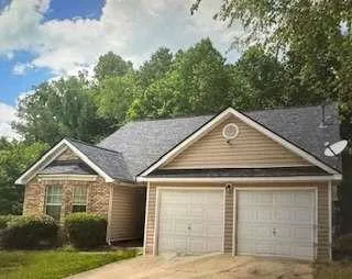 a front view of a house with garage