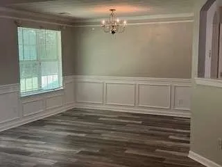 a view of a livingroom with wooden floor and window