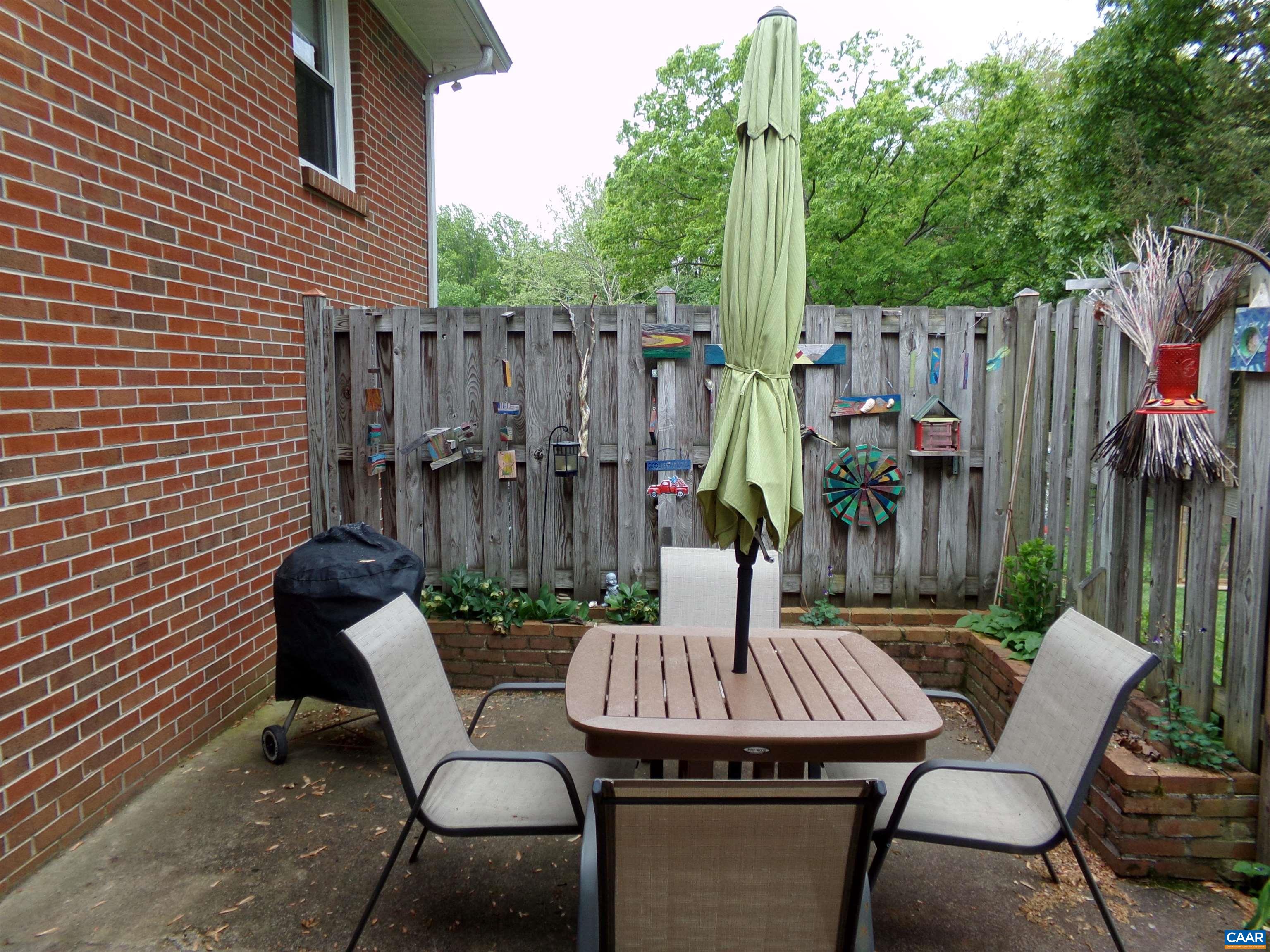 3011 Colonial Drive Charlottesville, VA 22911 - Photo 19 of 35 a view of a backyard with table and chairs potted plants and wooden fence