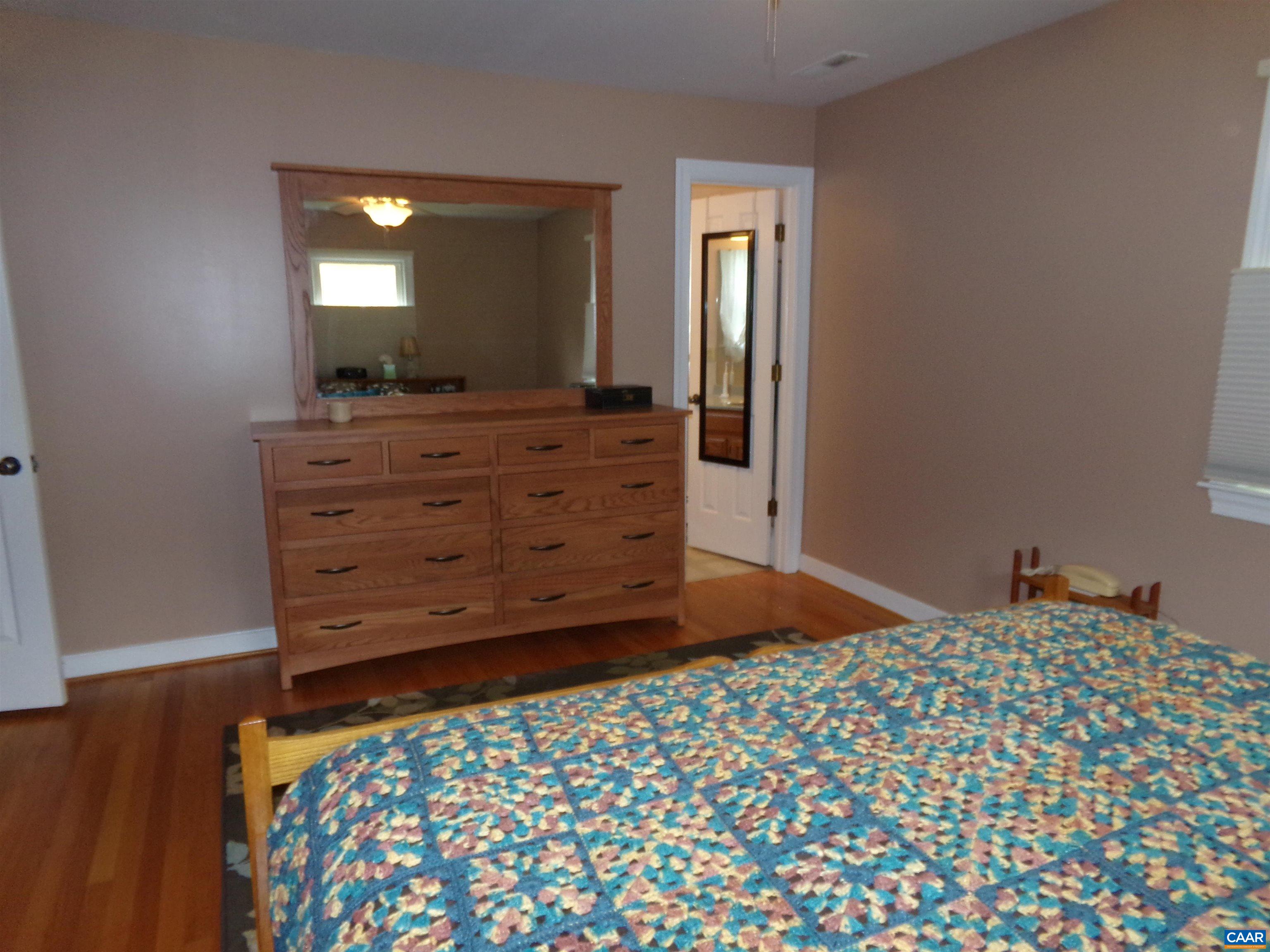 3011 Colonial Drive Charlottesville, VA 22911 - Photo 22 of 35 a bedroom with a bed and a mirror on dresser