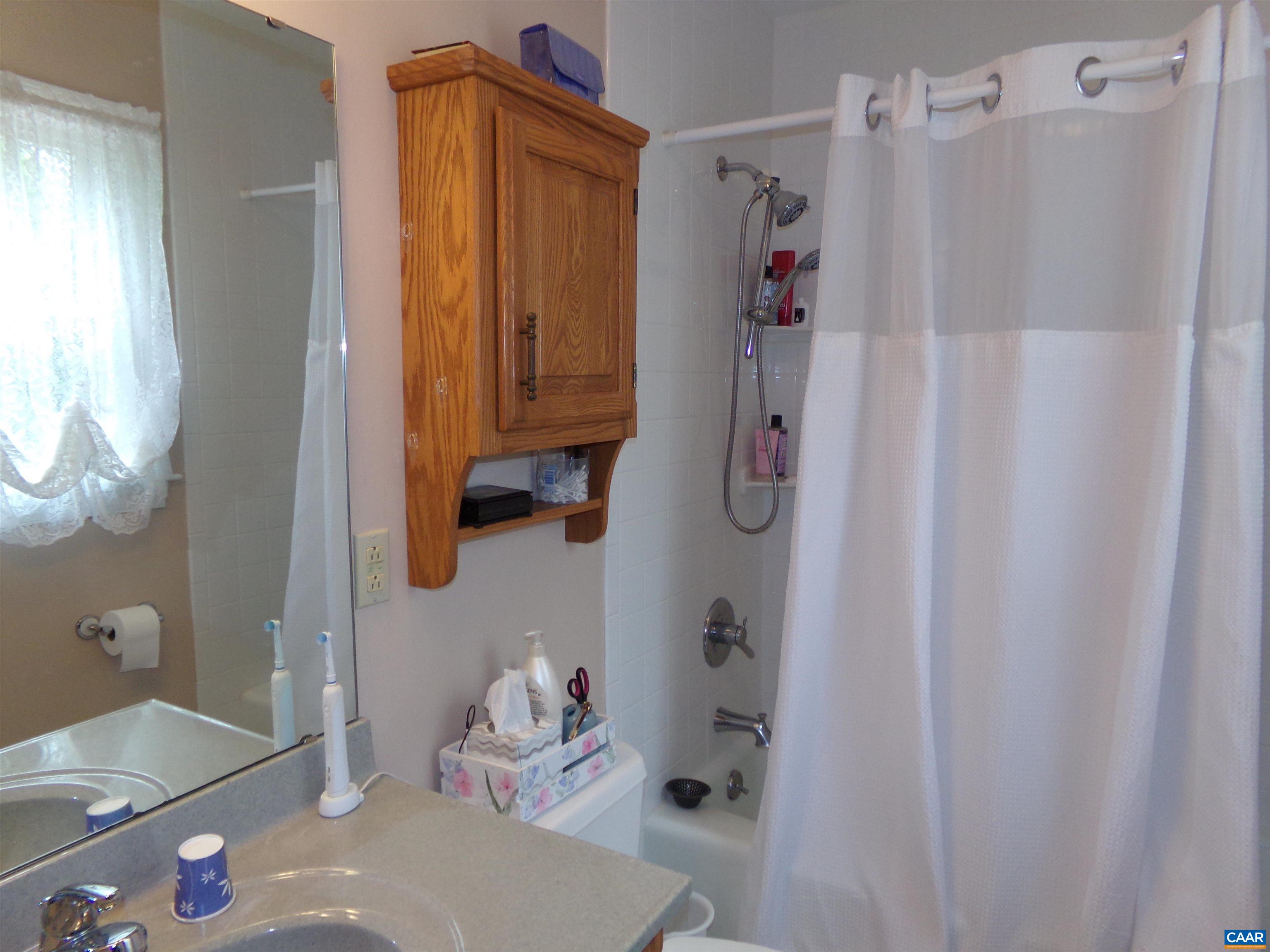 3011 Colonial Drive Charlottesville, VA 22911 - Photo 24 of 35 a bathroom with a tub sink and shower curtain