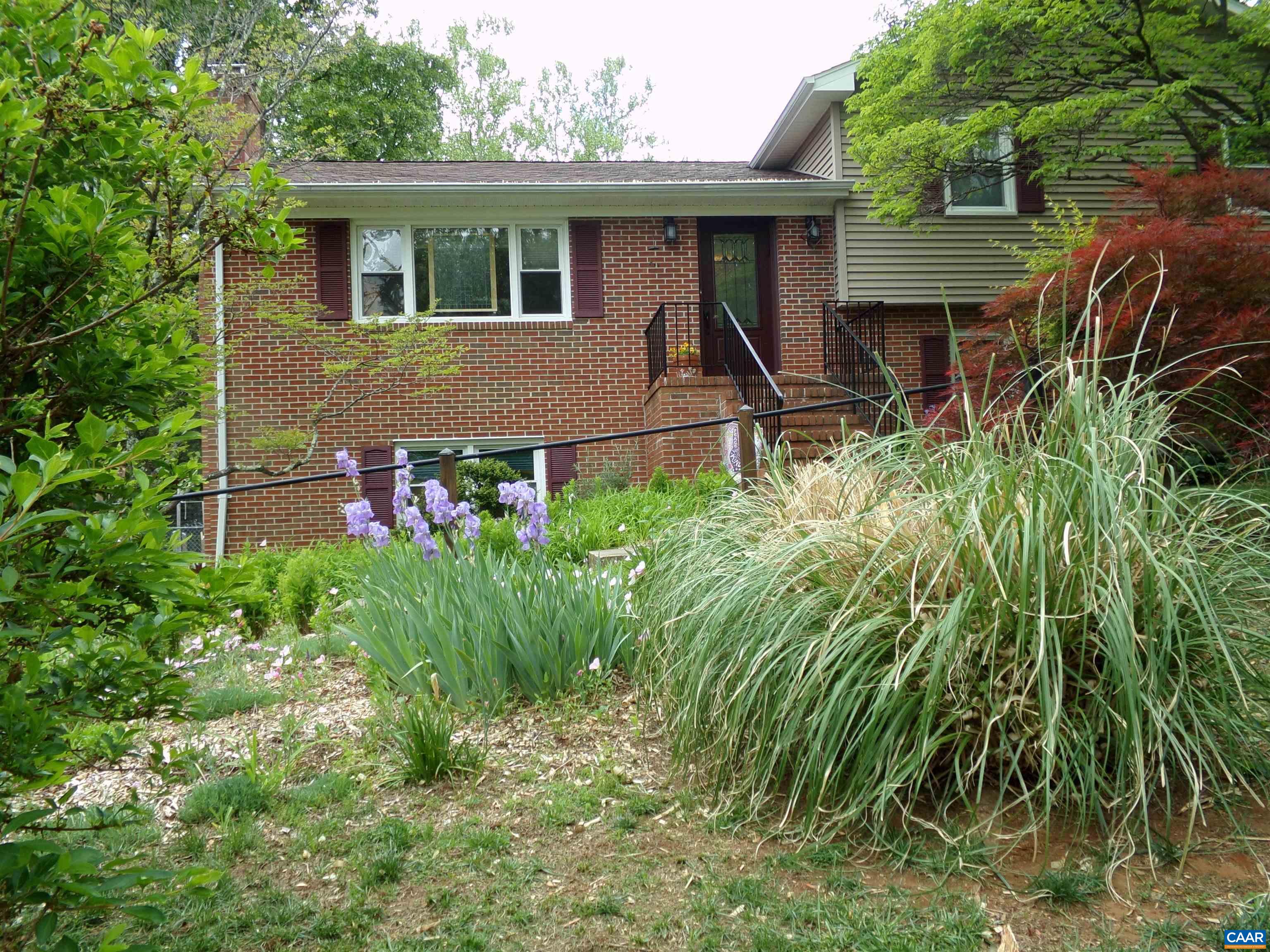 3011 Colonial Drive Charlottesville, VA 22911 - Photo 4 of 35 a view of a backyard with plants and a large tree