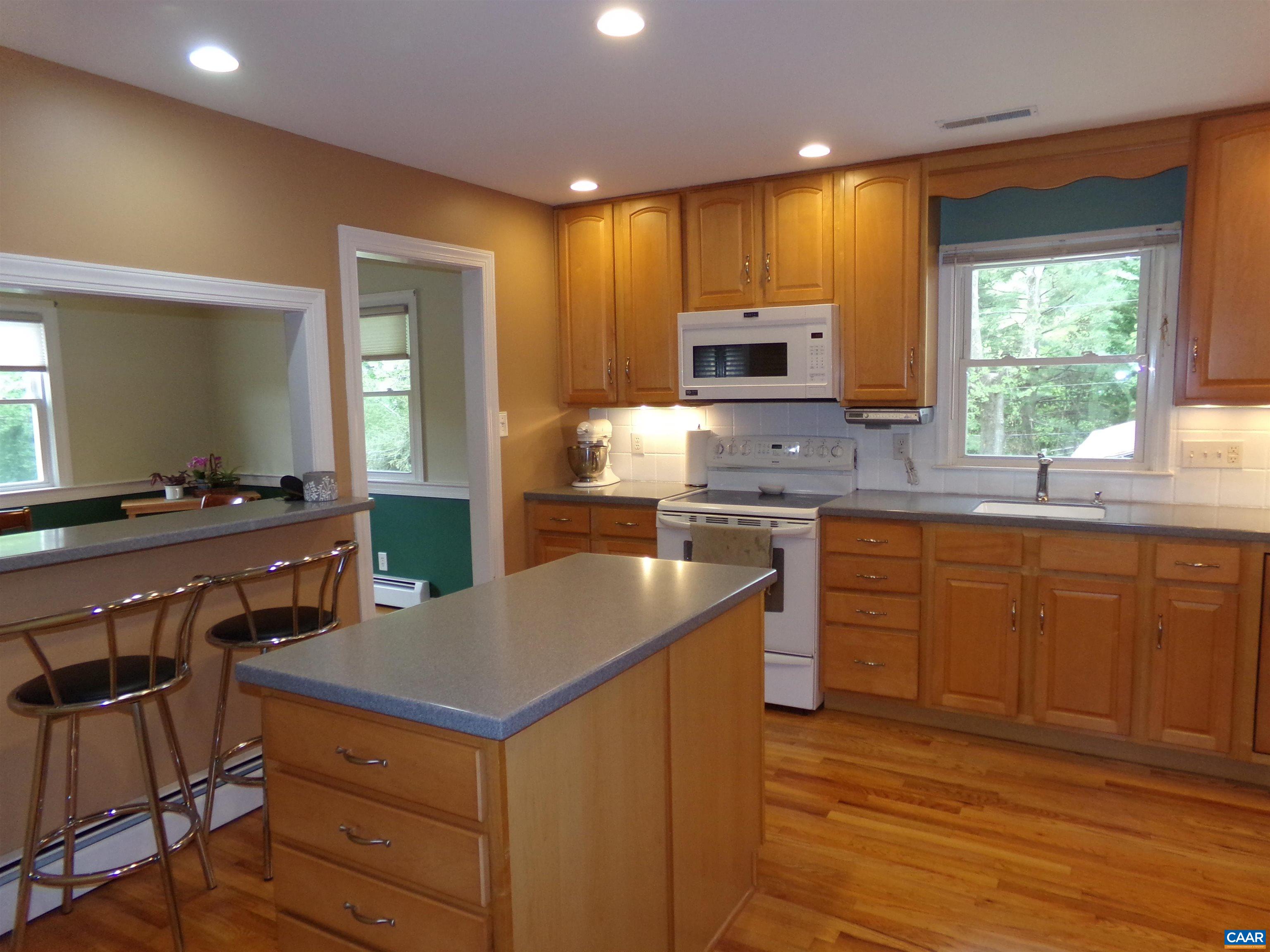 3011 Colonial Drive Charlottesville, VA 22911 - Photo 8 of 35 a kitchen with a stove a sink a microwave a counter space and cabinets