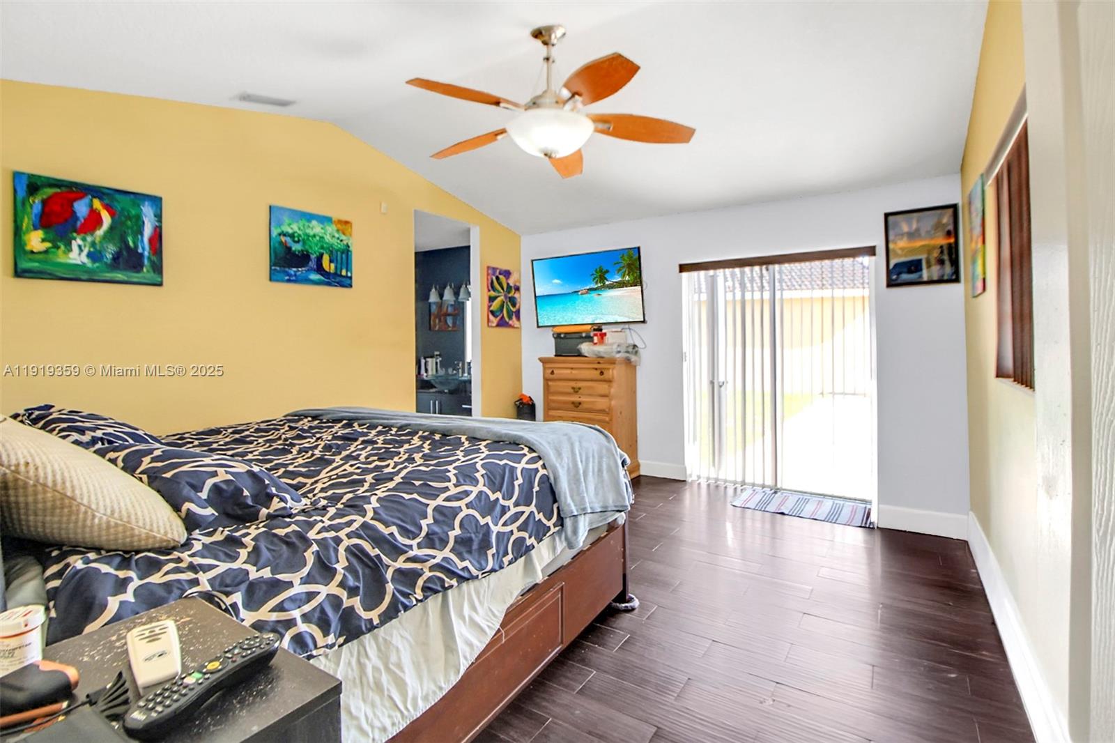 6122 Northwest 181st Terrace Circle West Hialeah, FL 33015 - Photo 11 of 28 a bedroom with a bed and a chandelier