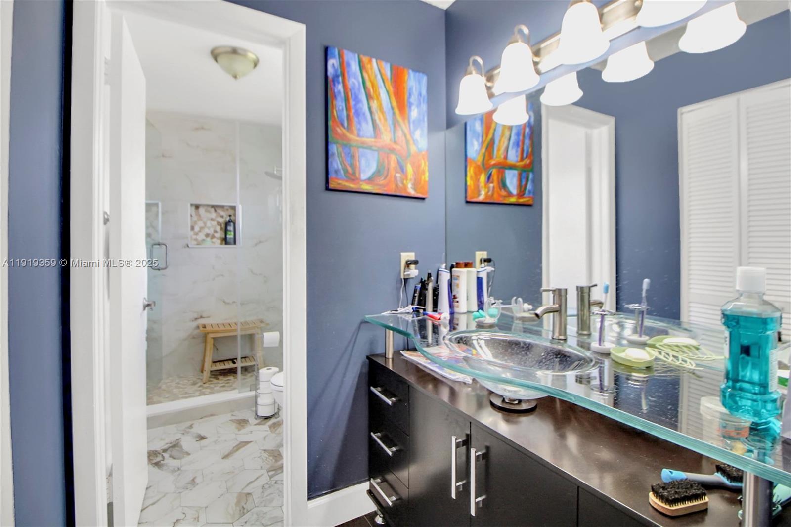 6122 Northwest 181st Terrace Circle West Hialeah, FL 33015 - Photo 12 of 28 a bathroom with a sink a vanity and a mirror