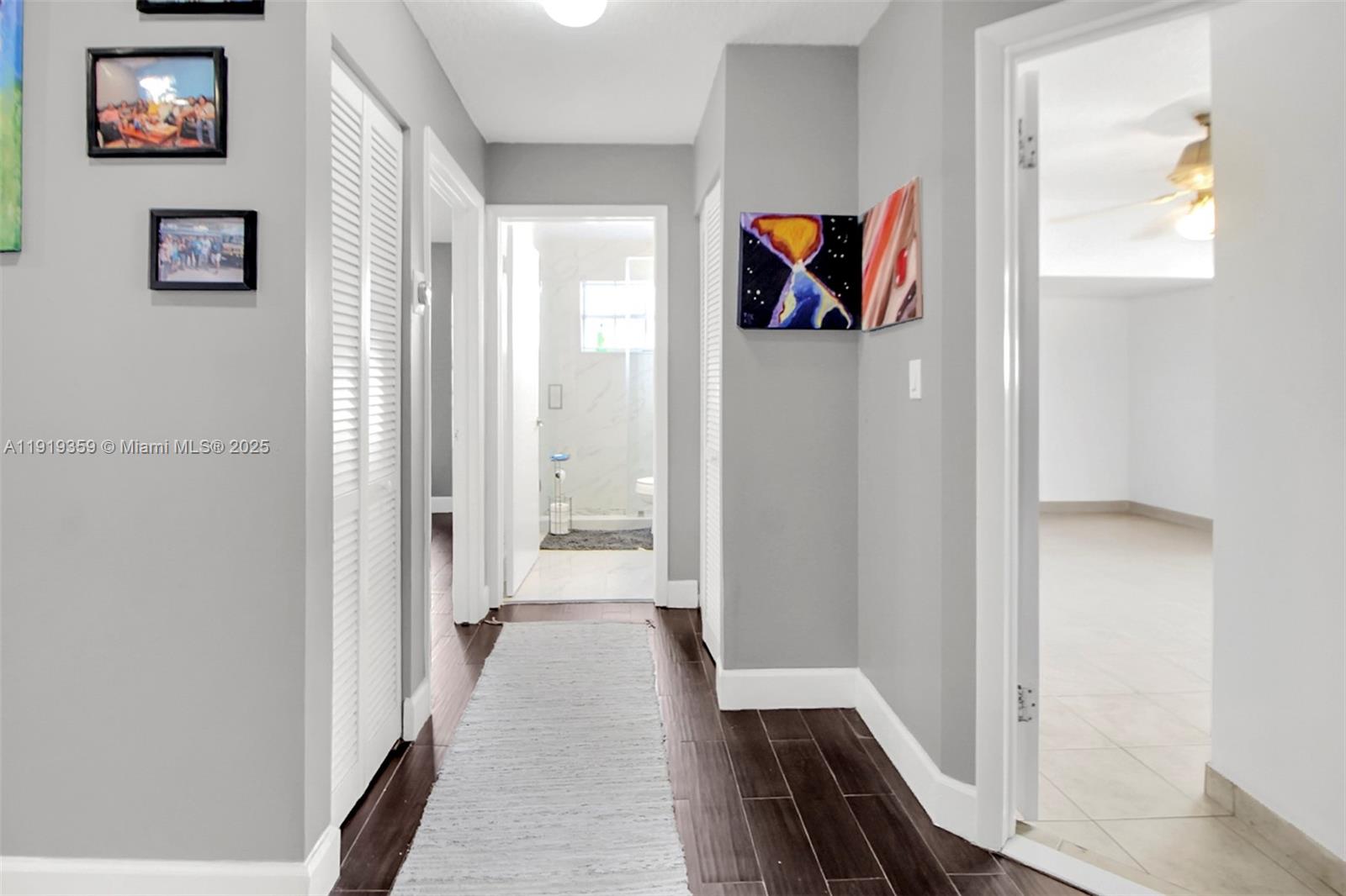 6122 Northwest 181st Terrace Circle West Hialeah, FL 33015 - Photo 14 of 28 a view of a hallway with wooden floor and windows
