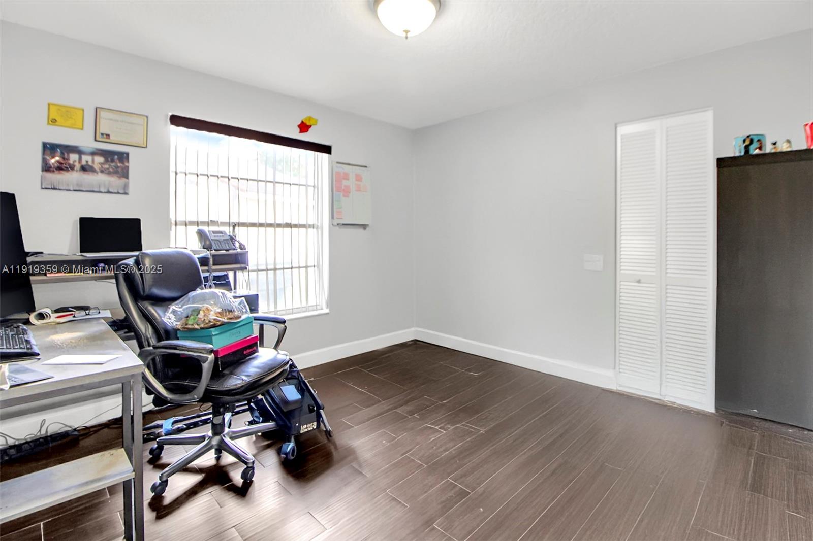 6122 Northwest 181st Terrace Circle West Hialeah, FL 33015 - Photo 17 of 28 a view of a workspace with furniture and a window