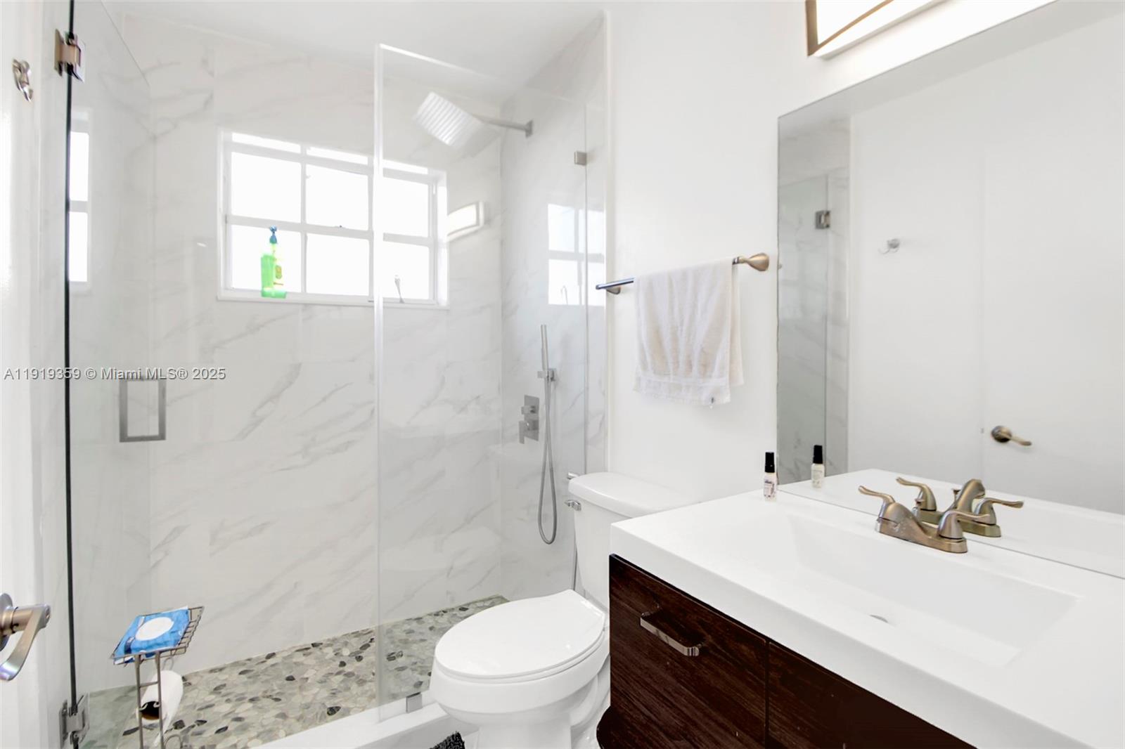 6122 Northwest 181st Terrace Circle West Hialeah, FL 33015 - Photo 18 of 28 a bathroom with a sink a toilet and shower