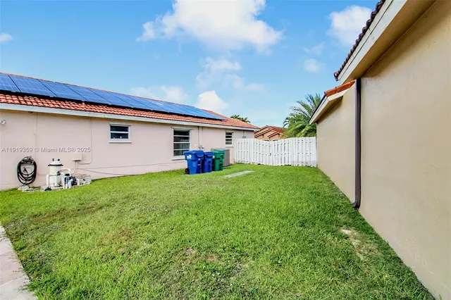 an aerial view of house with yard swimming pool and outdoor seating