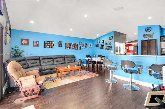 a bed sitting in a bedroom next to a window and a chandelier