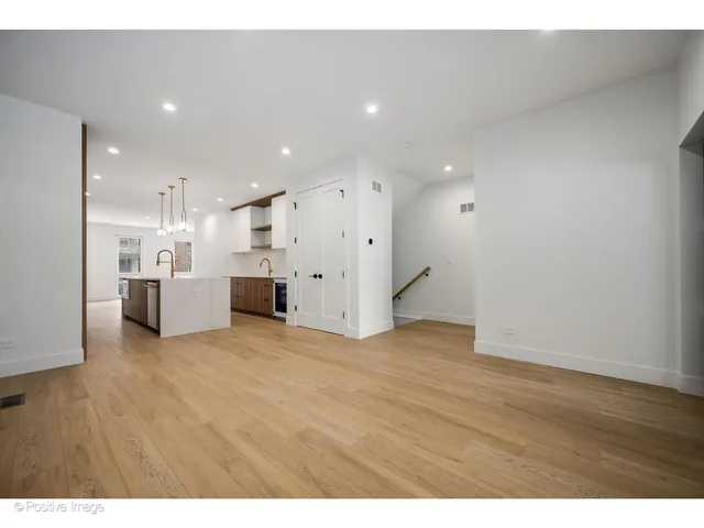 a view of a kitchen with a refrigerator and a sink