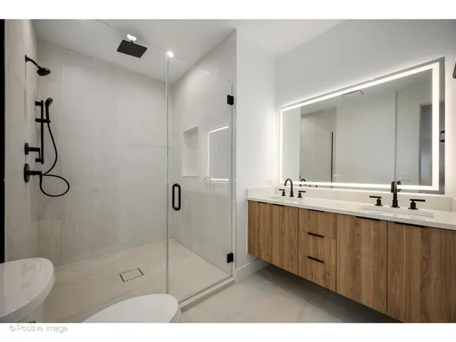a bathroom with a shower sink and mirror
