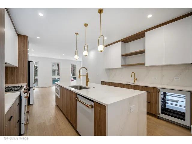 a kitchen with stainless steel appliances a sink stove and cabinets