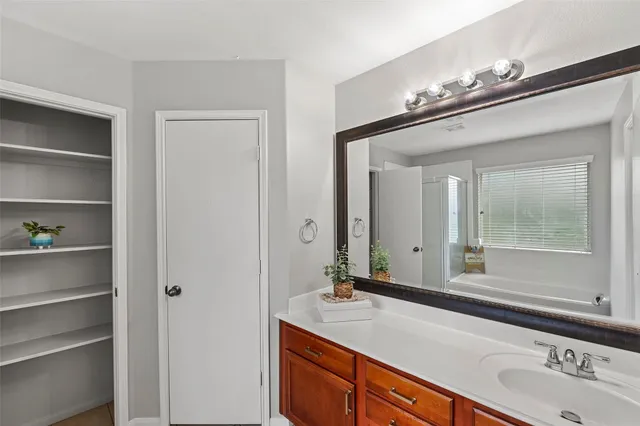 a bathroom with a double vanity sink and a mirror