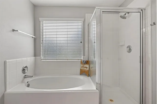 a white bath tub sitting next to a shower