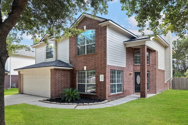 a front view of a house with a garden and yard
