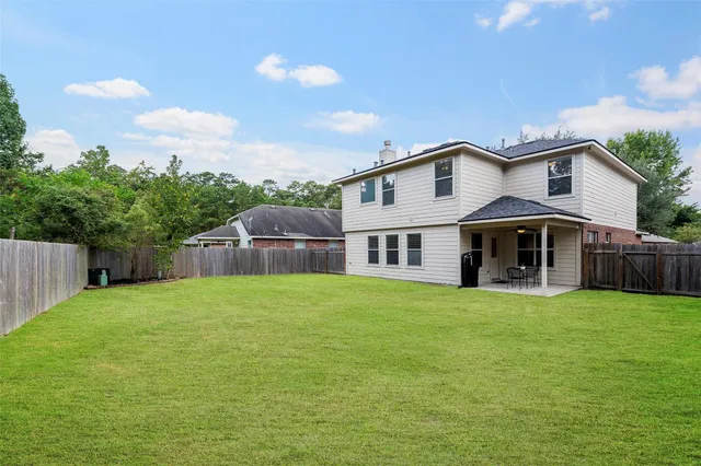 a house that has a big yard and large trees
