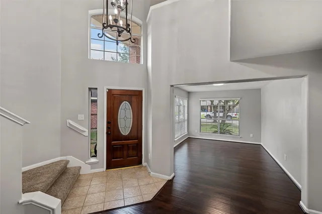 a view of a livingroom with furniture wooden floor windows and closet