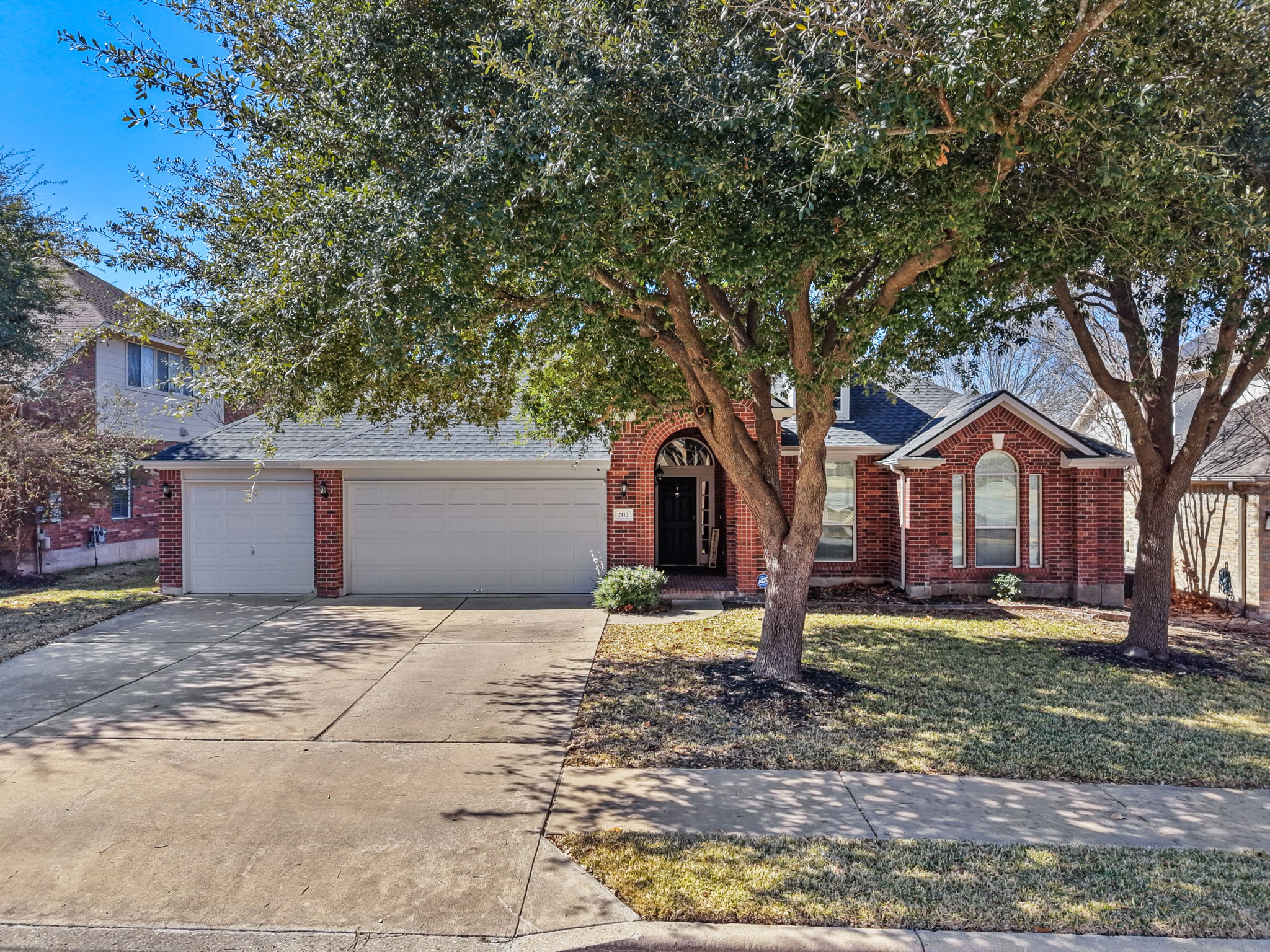 2112 Bandera Path Round Rock, TX 78665 - Photo 2 of 34 a house with a large tree in front of it