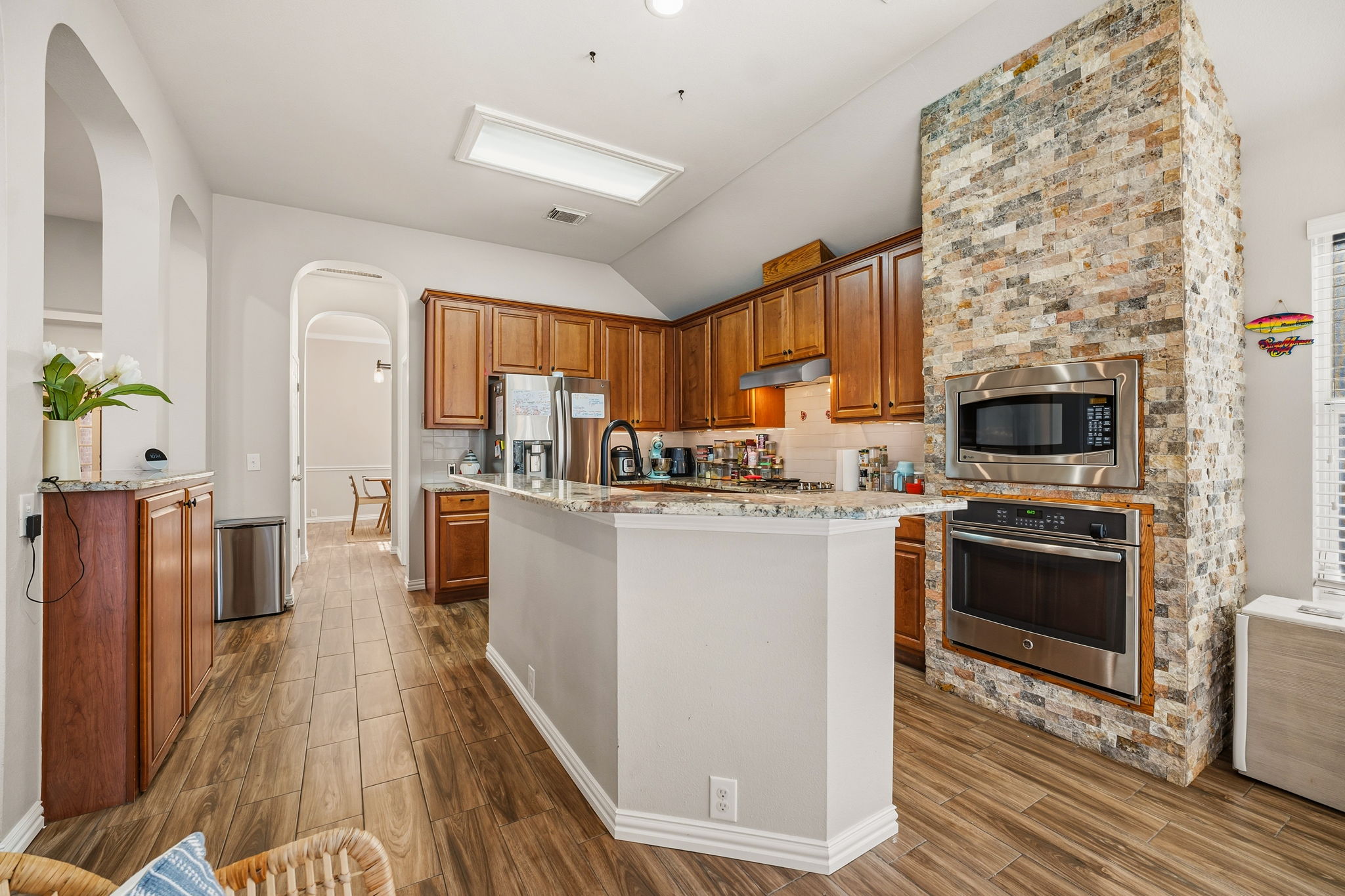 2112 Bandera Path Round Rock, TX 78665 - Photo 7 of 34 a kitchen with stainless steel appliances granite countertop a refrigerator a stove top oven a sink dishwasher and wooden floor