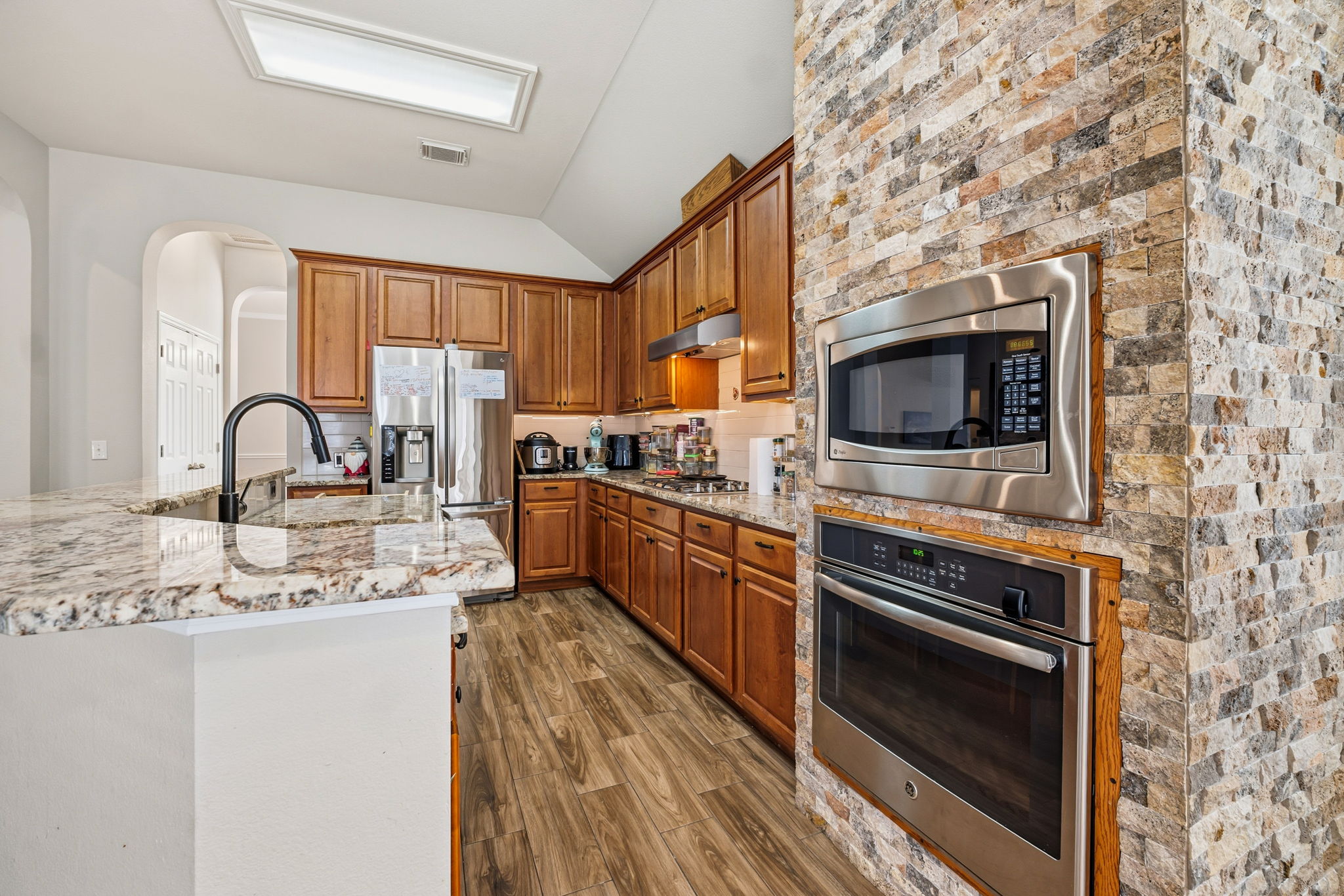 2112 Bandera Path Round Rock, TX 78665 - Photo 9 of 34 a kitchen with stainless steel appliances a stove a sink and a microwave