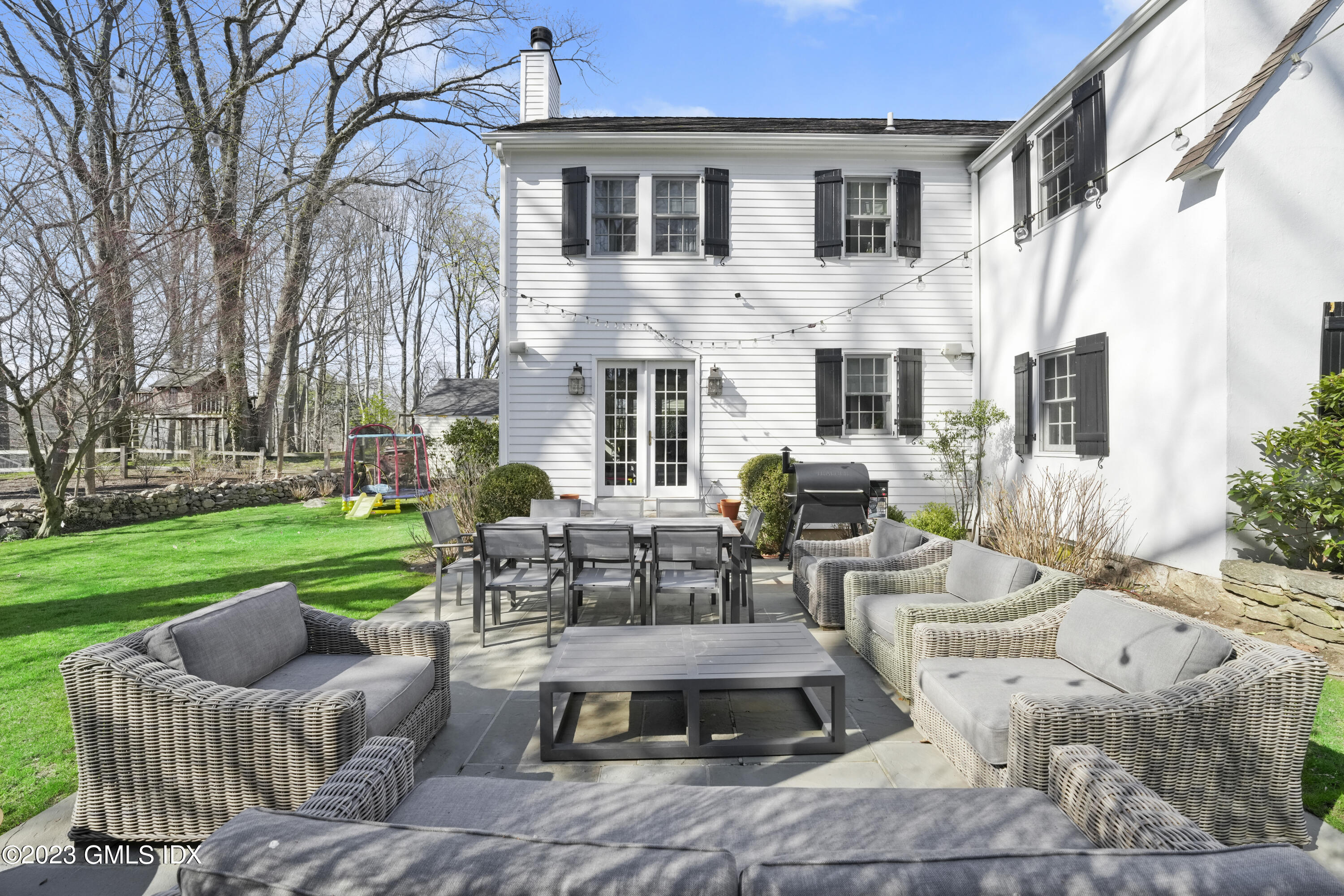 46 Terrace Avenue Riverside, CT 06878 - Photo 14 of 17 a view of a patio with couches table and chairs with plants and wooden fence