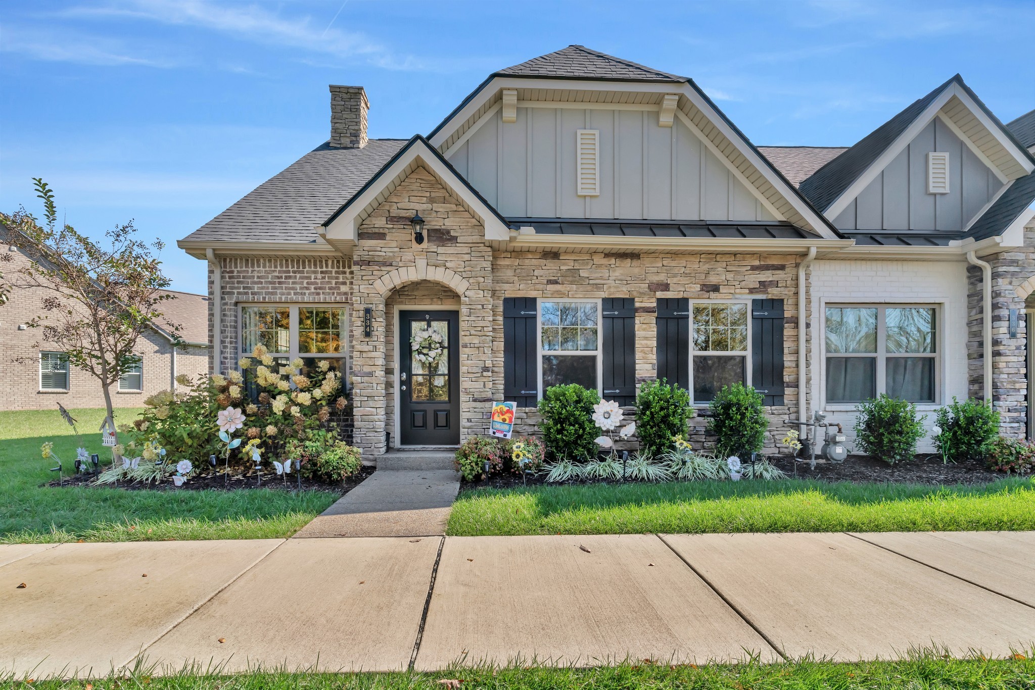 a front view of a house with garden