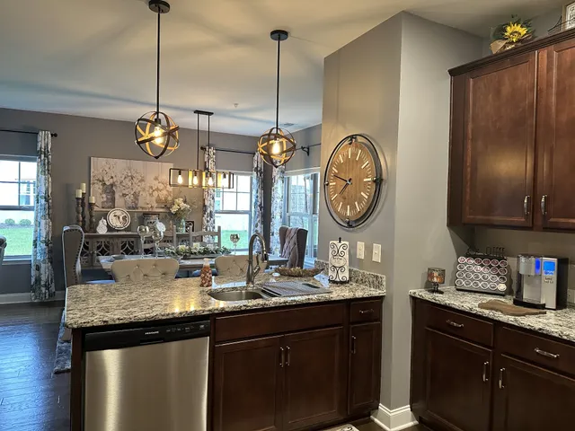 a kitchen with a refrigerator a sink and cabinets