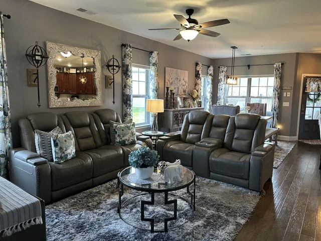a living room with furniture potted plant and a window